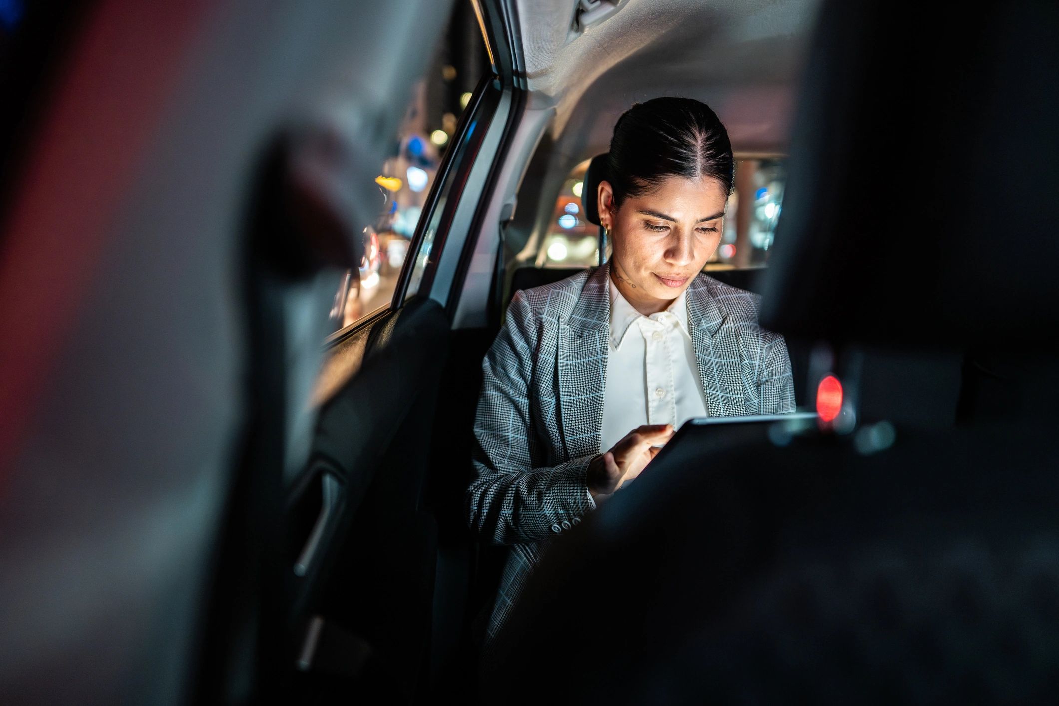Business traveler using a tablet in a premium ride
